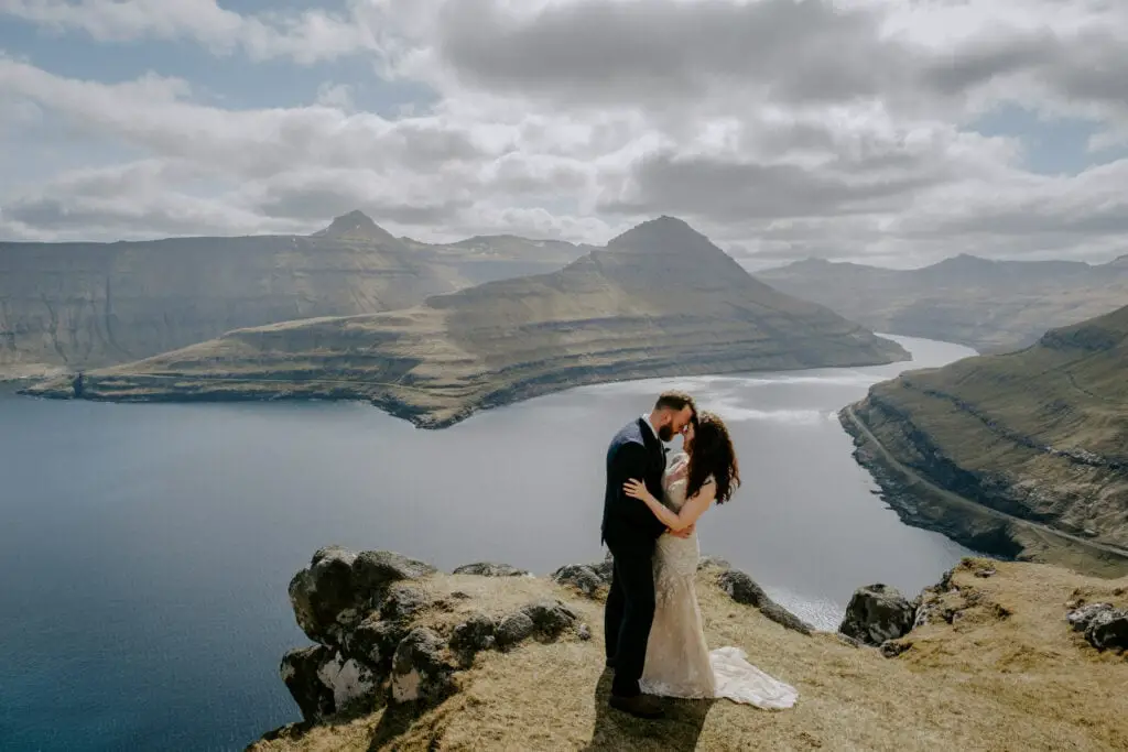 Bride and groom on cliffs in the Faroe Islands
