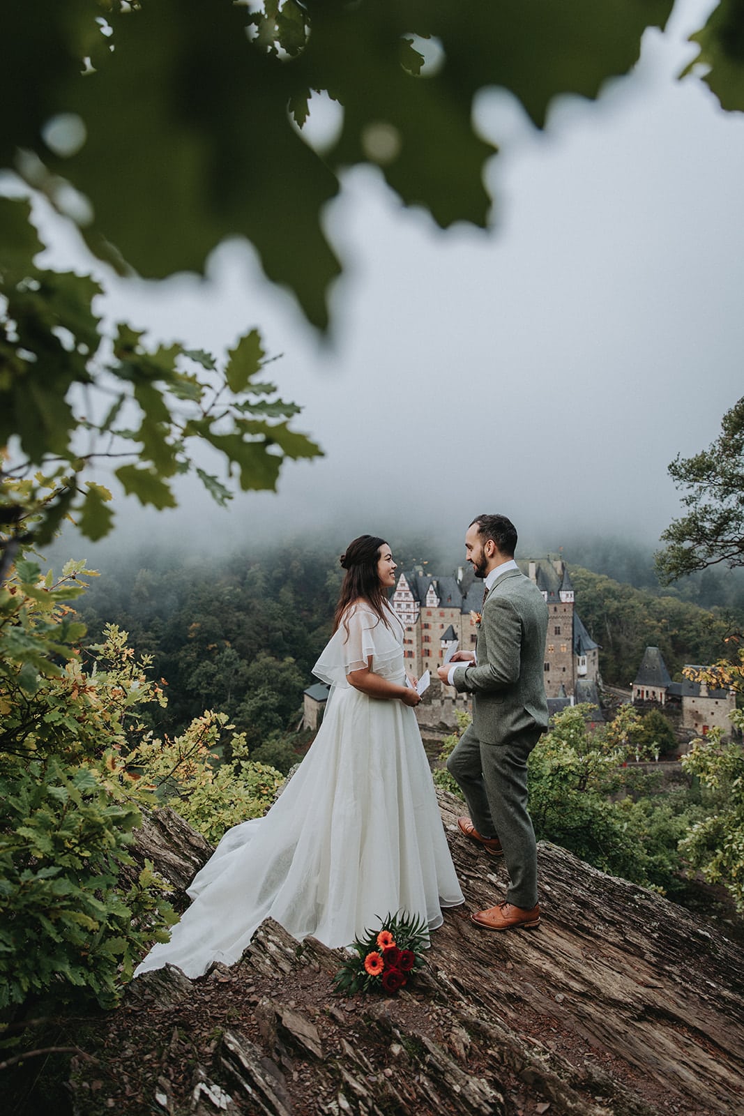 Bride and groom exchange wedding vows in front of Eltz castle in Germany