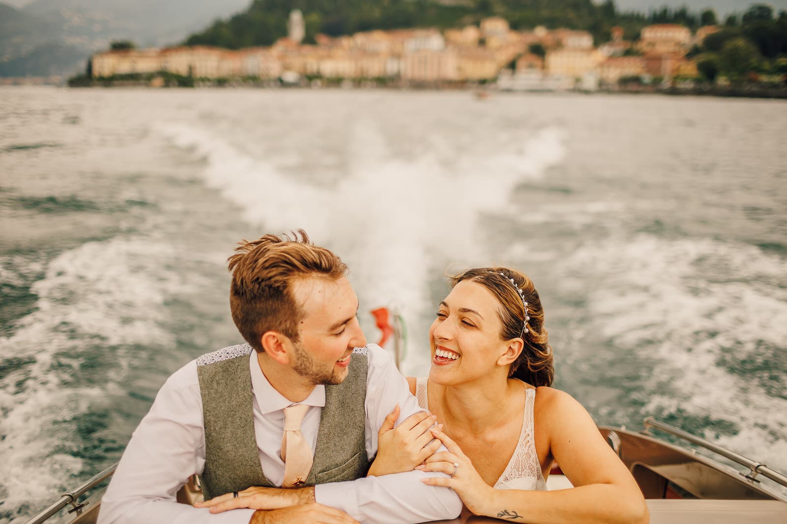 Bride and groom take a ride on a boat on Lake Como