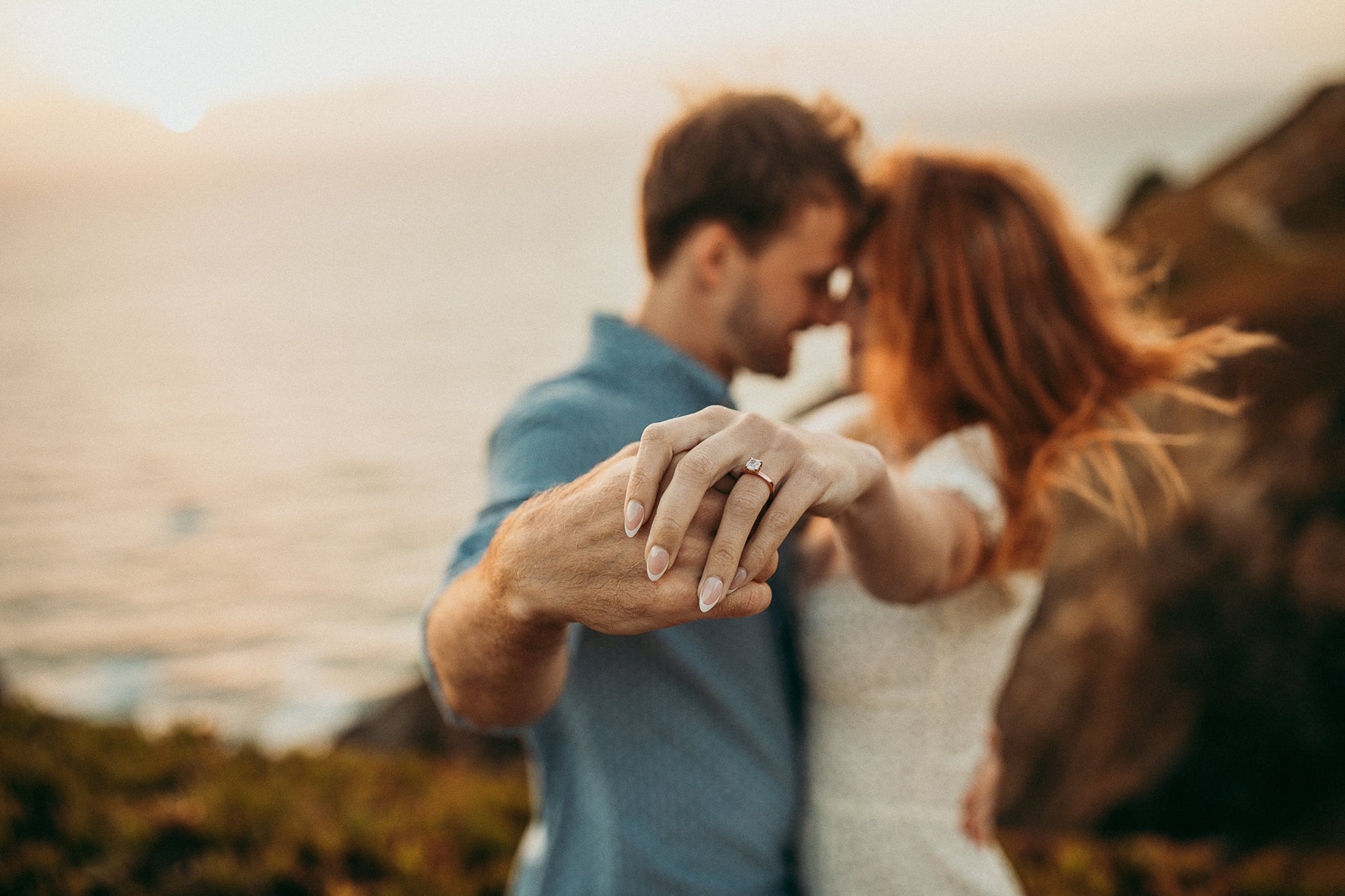 Wedding proposal at Cabo da Roca in Portugal close up of hands with engagement ring