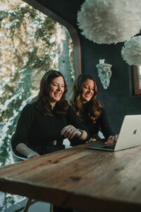 Photo of two women, Jlenia Costner and Gemma Garriga, sitting at a laptop and smiling